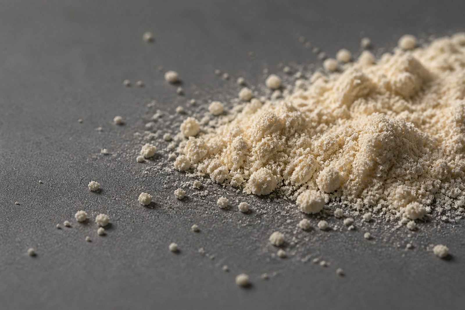 An extreme macro of the cream Daily Calm Focus powder under raking light