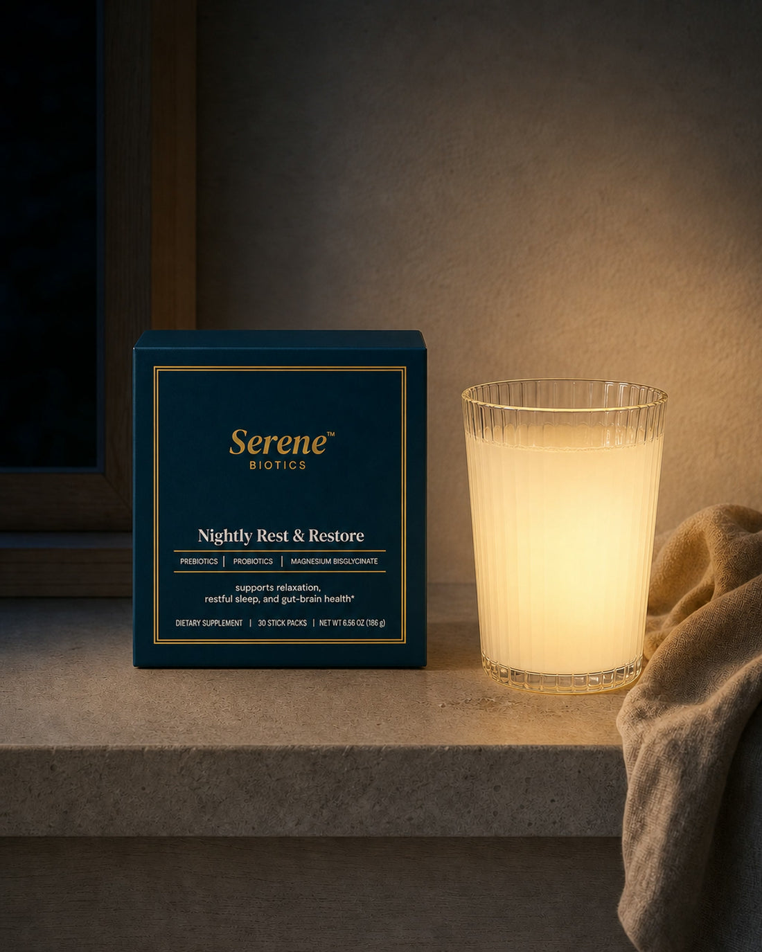 The same place at night: the teal Nightly Rest and Restore carton and the pale drink by lamplight