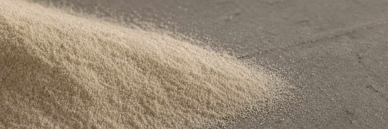 Fine crystalline powder in a soft drift on cool stone