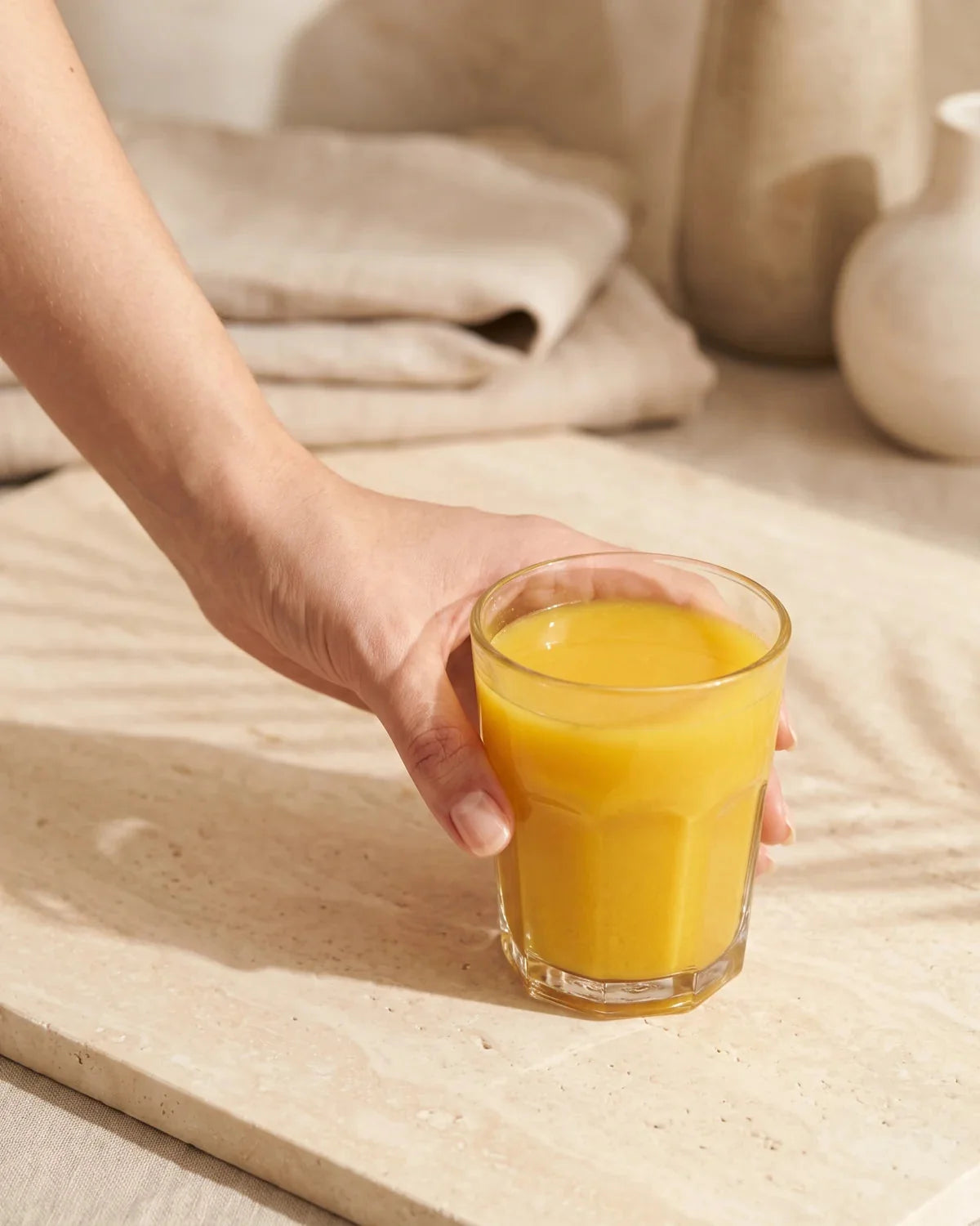 A hand setting down a prepared Daily Calm Focus drink