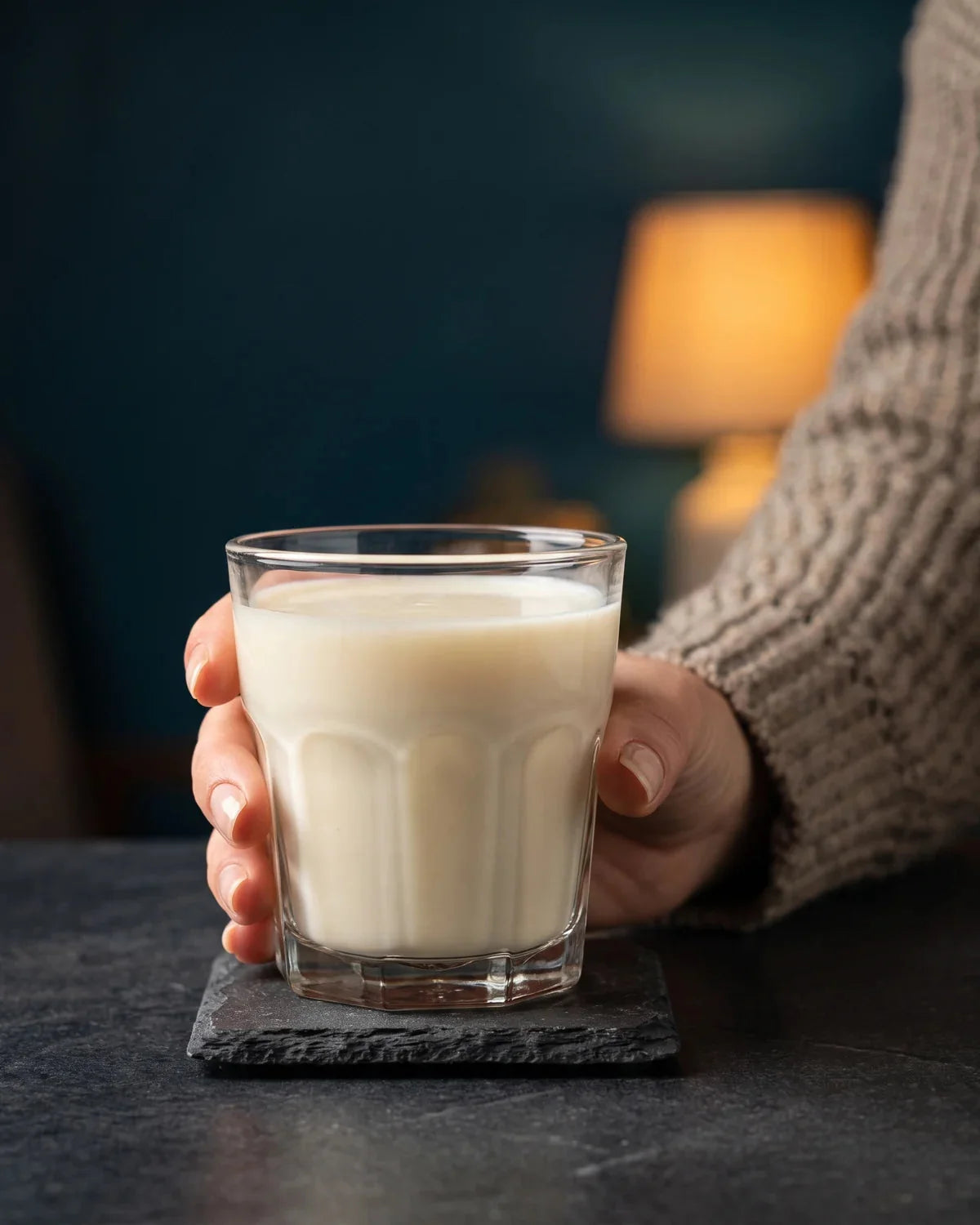 A hand holding a prepared Nightly Rest and Restore drink