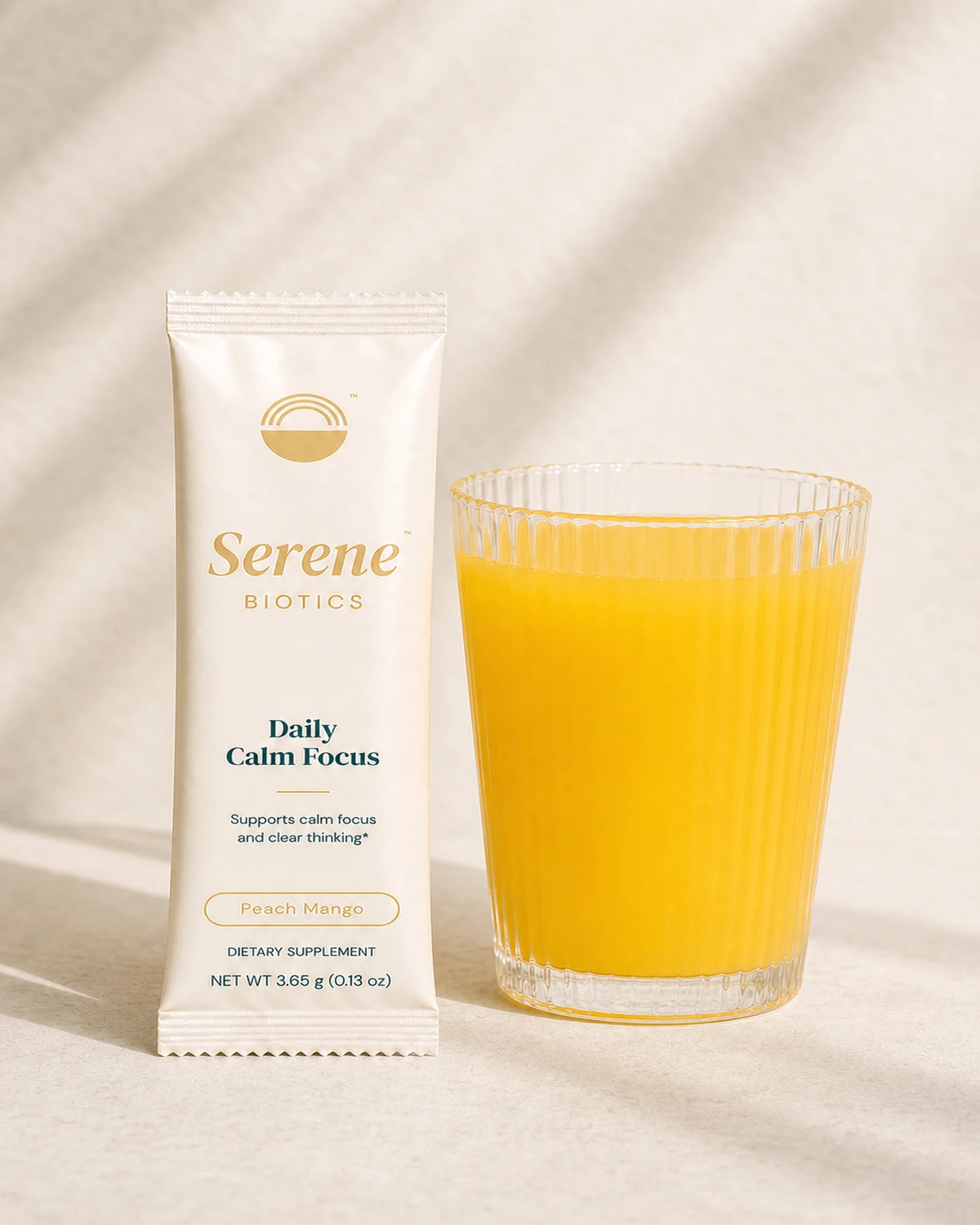 Daily Calm Focus stick pack beside the prepared golden drink