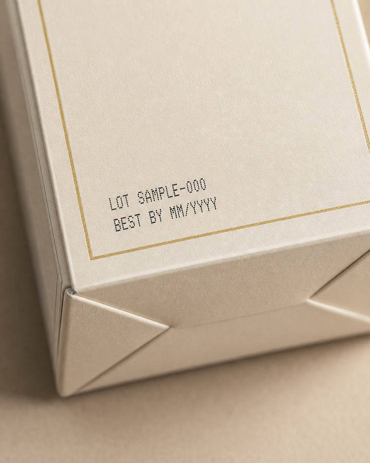 The lot code and best-by date printed on the base panel of a Serene Biotics carton